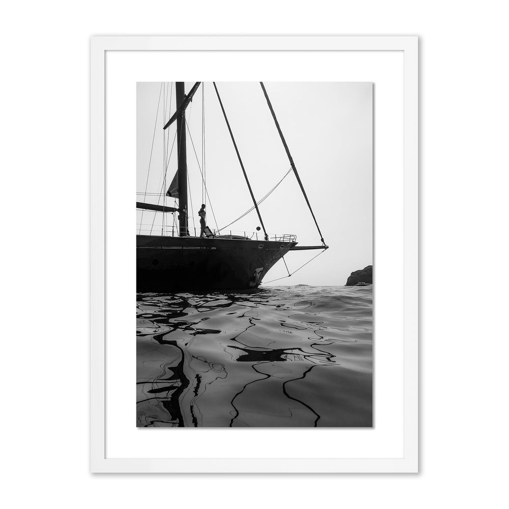 Front view of Li Galli Island framed print showing sailboat bow silhouette and rippled water reflections with white mat