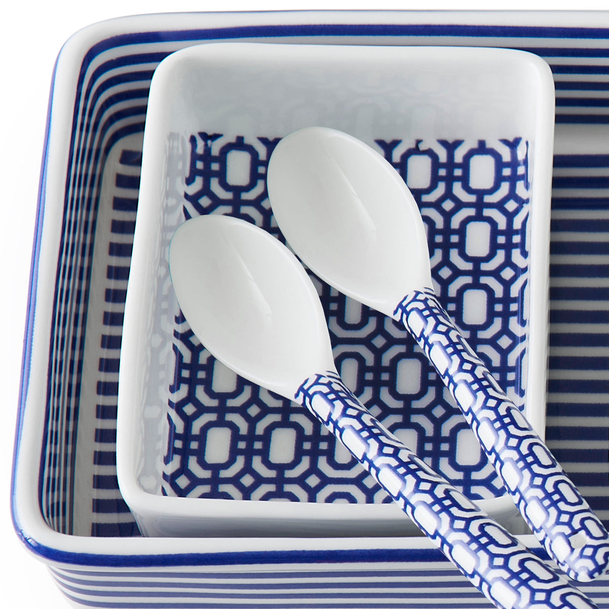 Close-up view of Newport Small Spoon, Set of 6 showcasing blue geometric patterned handles with a matching tray background