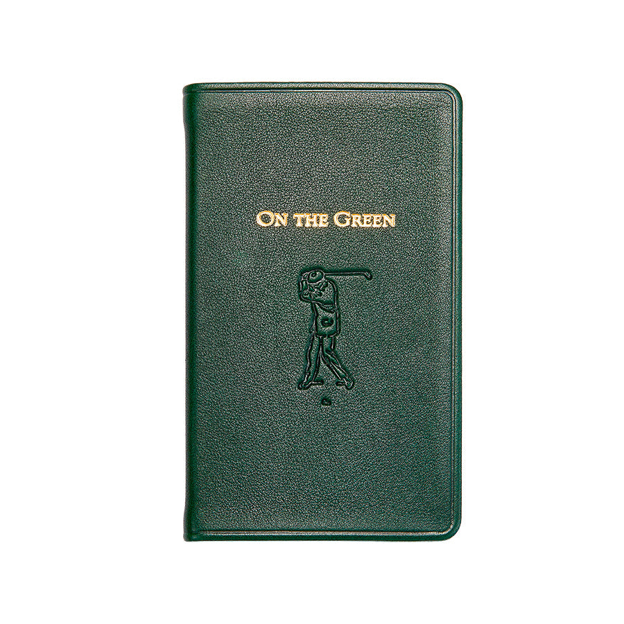 Front view of On the Green compact score book, green leather cover with gold foil title and embossed golfer