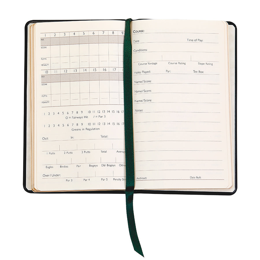 Open view of On the Green Compact Score Book showing ruled scorecard pages and a green ribbon on white background