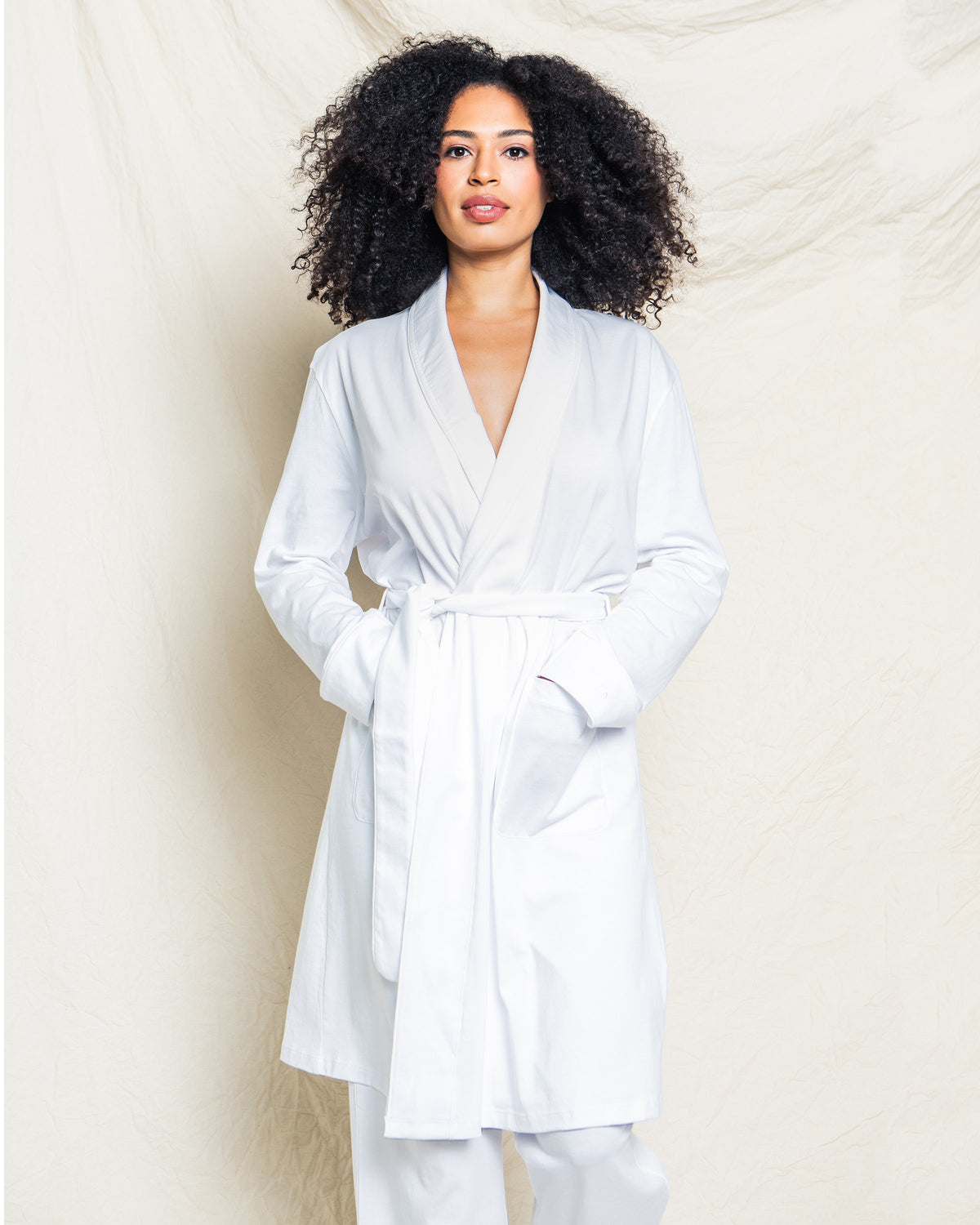 Front view of Women’s White Pima Cotton Robe showcasing wrap front, tie belt, and pockets with a light fabric backdrop