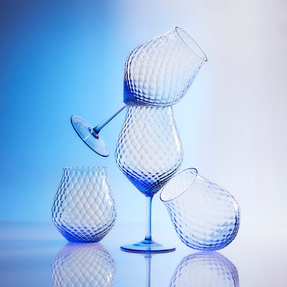 Phoebe cobalt blue mouth blown diamond optic crystal glasses from Caskata, both universal stemware and stemless wine glasses pictured.