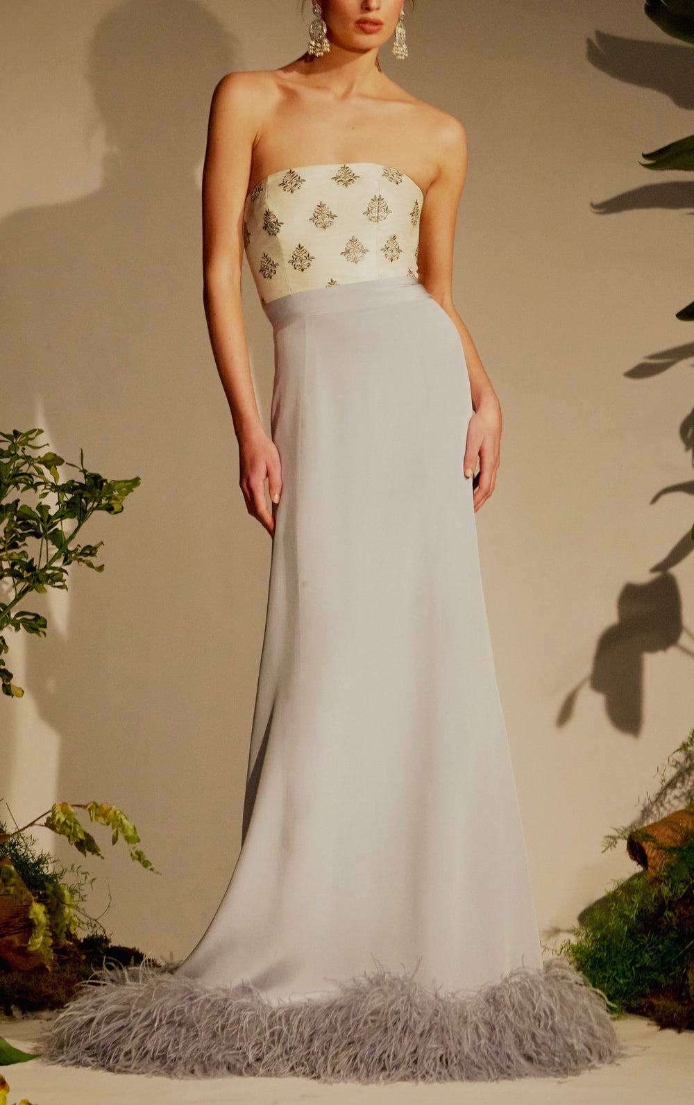 Front view of Leela Dress showing strapless embroidered cream bustier, periwinkle silk skirt, and feather-trim hem