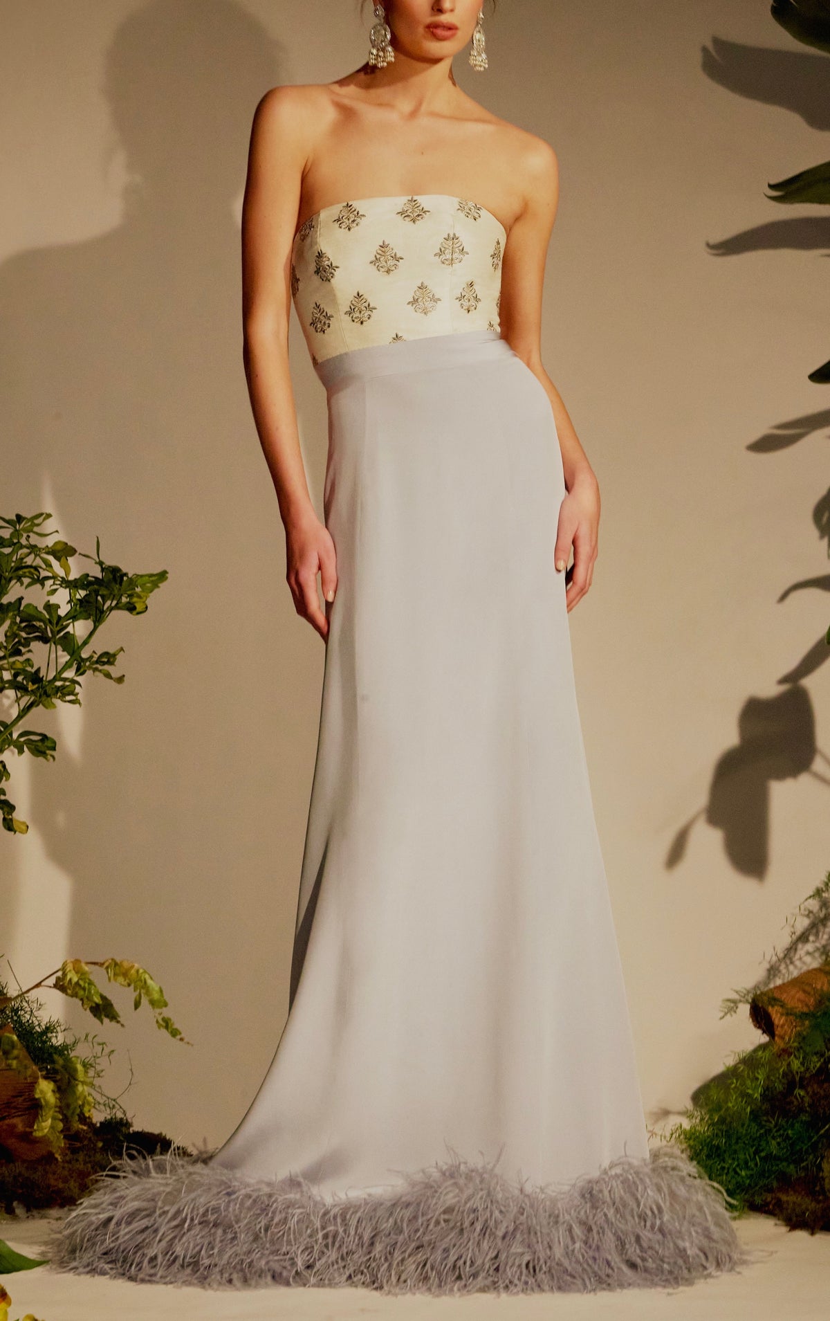 Front view of Leela Dress showing strapless embroidered cream bustier, periwinkle silk skirt, and feather-trim hem