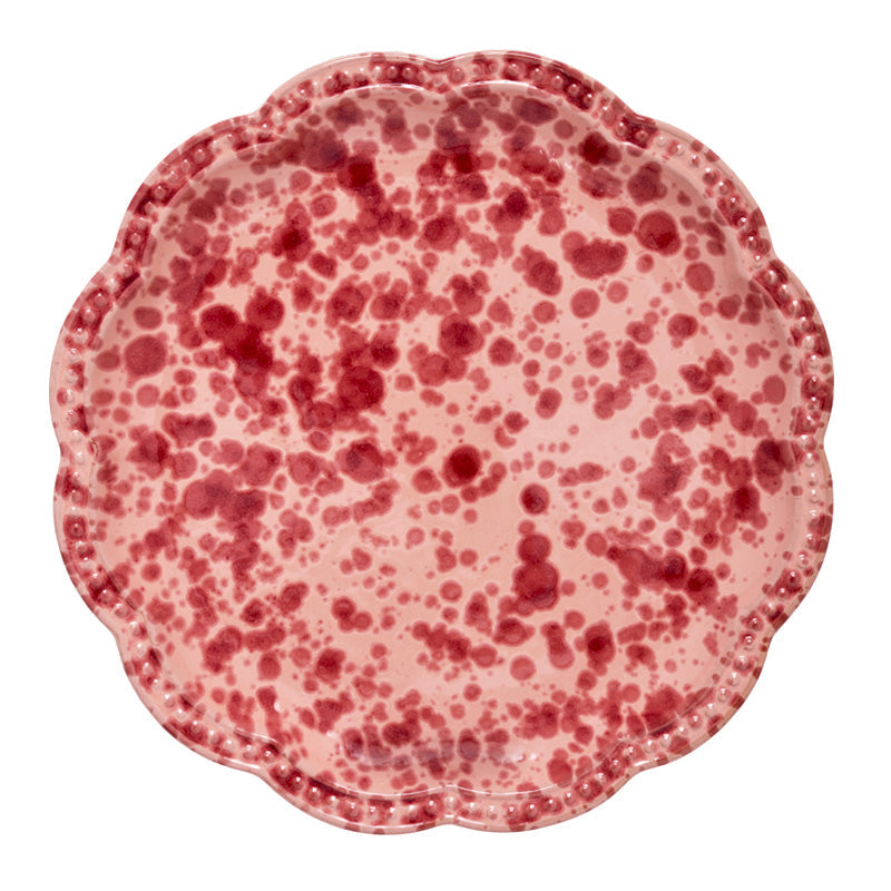 Top view of Speckled Dinner Plate in Pink showcasing hand-painted speckles, scalloped edge, and undulating rim on white