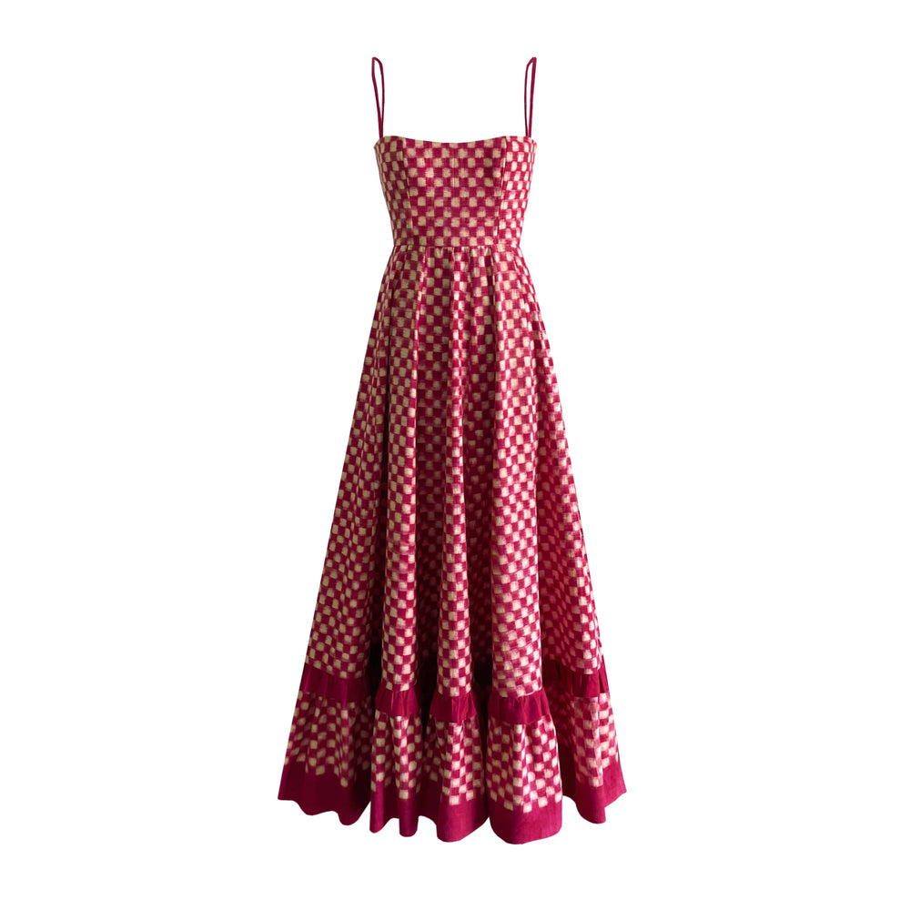 Front view of Red Checkmate Dress showcasing its cinched waist, corset bodice, and tiered ikat skirt on white background