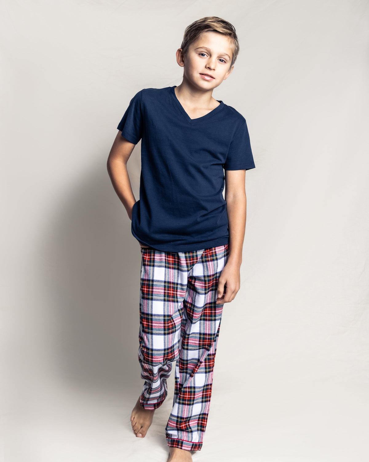 Front view of Children’s Balmoral tartan pajama pants on child model, red navy tartan on white, relaxed fit
