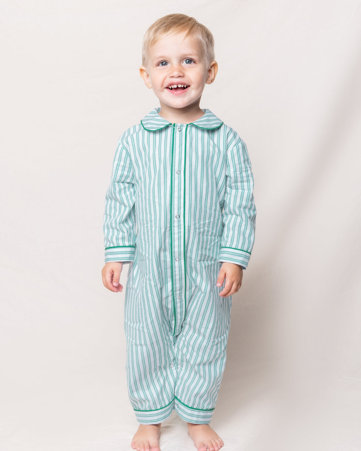 Front view of Emerald Ticking Cambridge Romper with French ticking stripes and snap front, worn by child against light background
