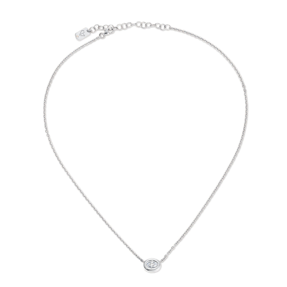 Top-down view of Ovalis necklace showcasing a puffy bezel oval diamond pendant on a delicate 14K white gold chain with white background