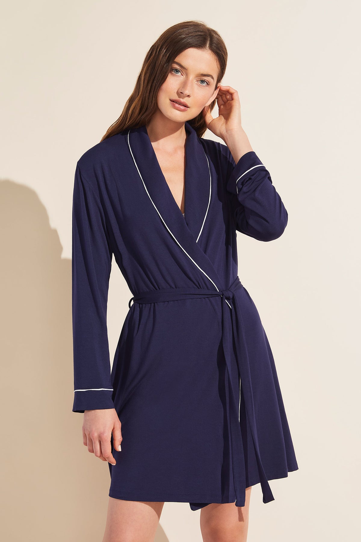 Front view of Gisele Tuxedo Robe in navy and ivory on a model, showcasing ivory piping and adjustable belt against beige background