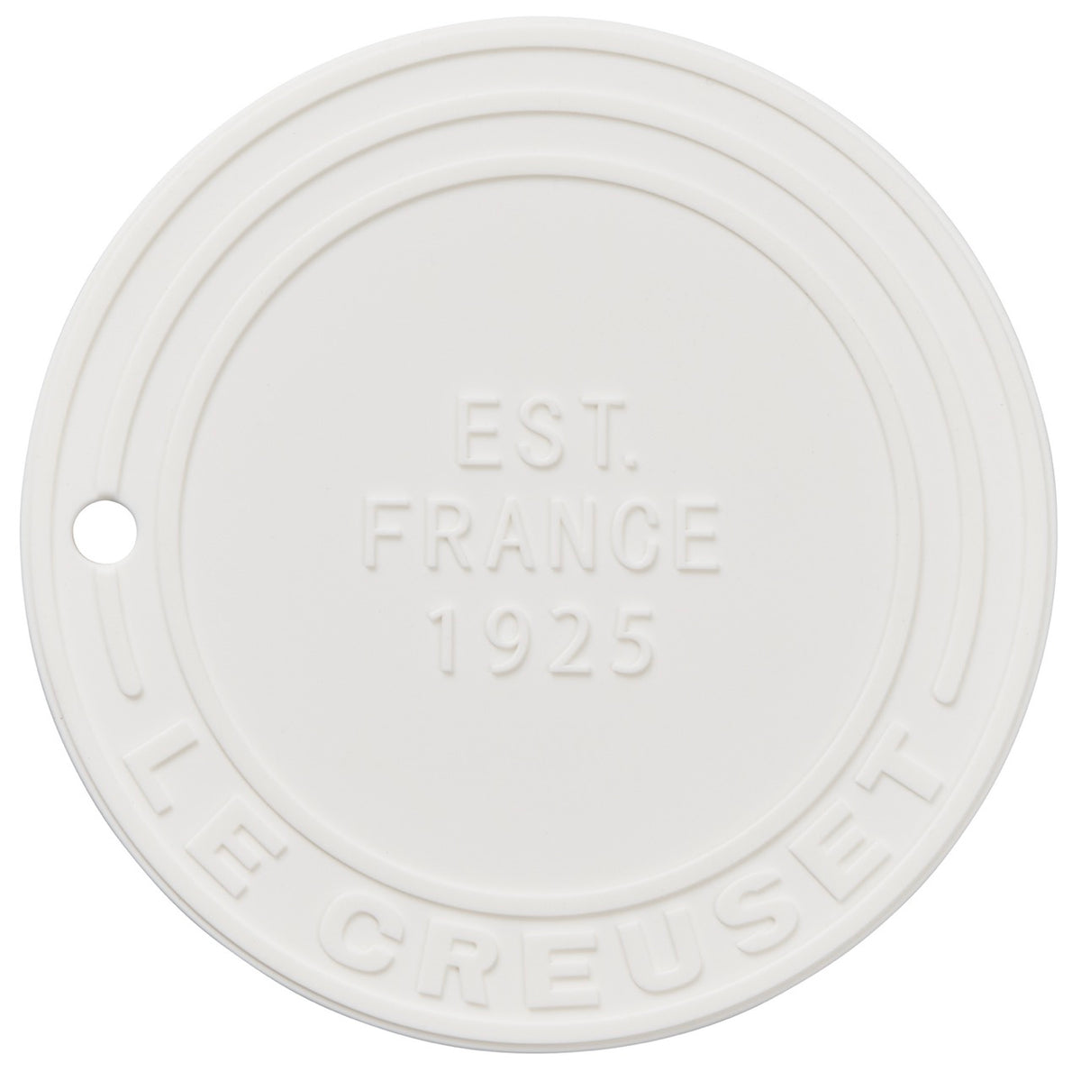 Top view of white silicone trivet showing embossed EST FRANCE 1925 and LE CREUSET text with small hanging hole