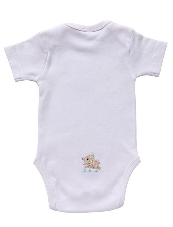 Rear view of white short sleeve onesie showcasing small embroidered bunny near bottom on plain white background