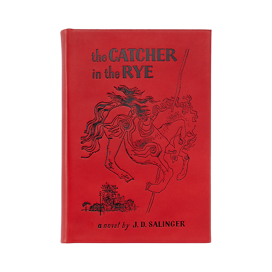 Front view of The Catcher in the Rye in bonded leather showing red cover with black embossed carousel horse illustration on white background