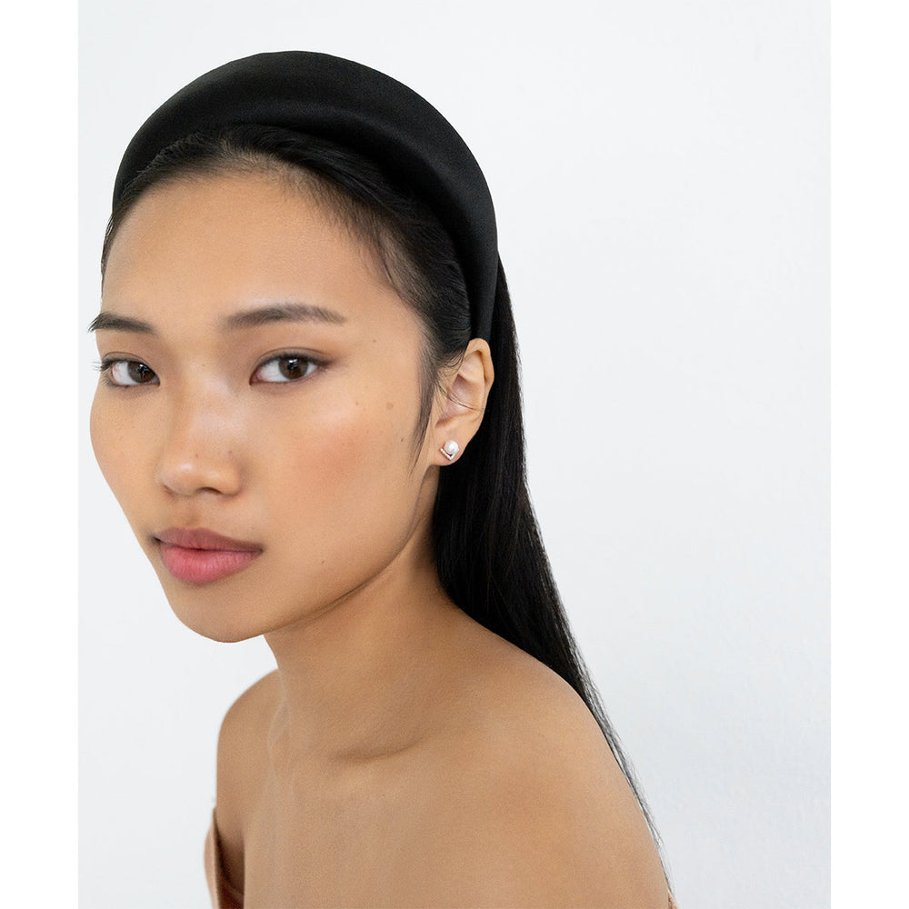 Three-quarter view of model wearing 14K yellow gold right-angle pearl stud with diamond accent on white background