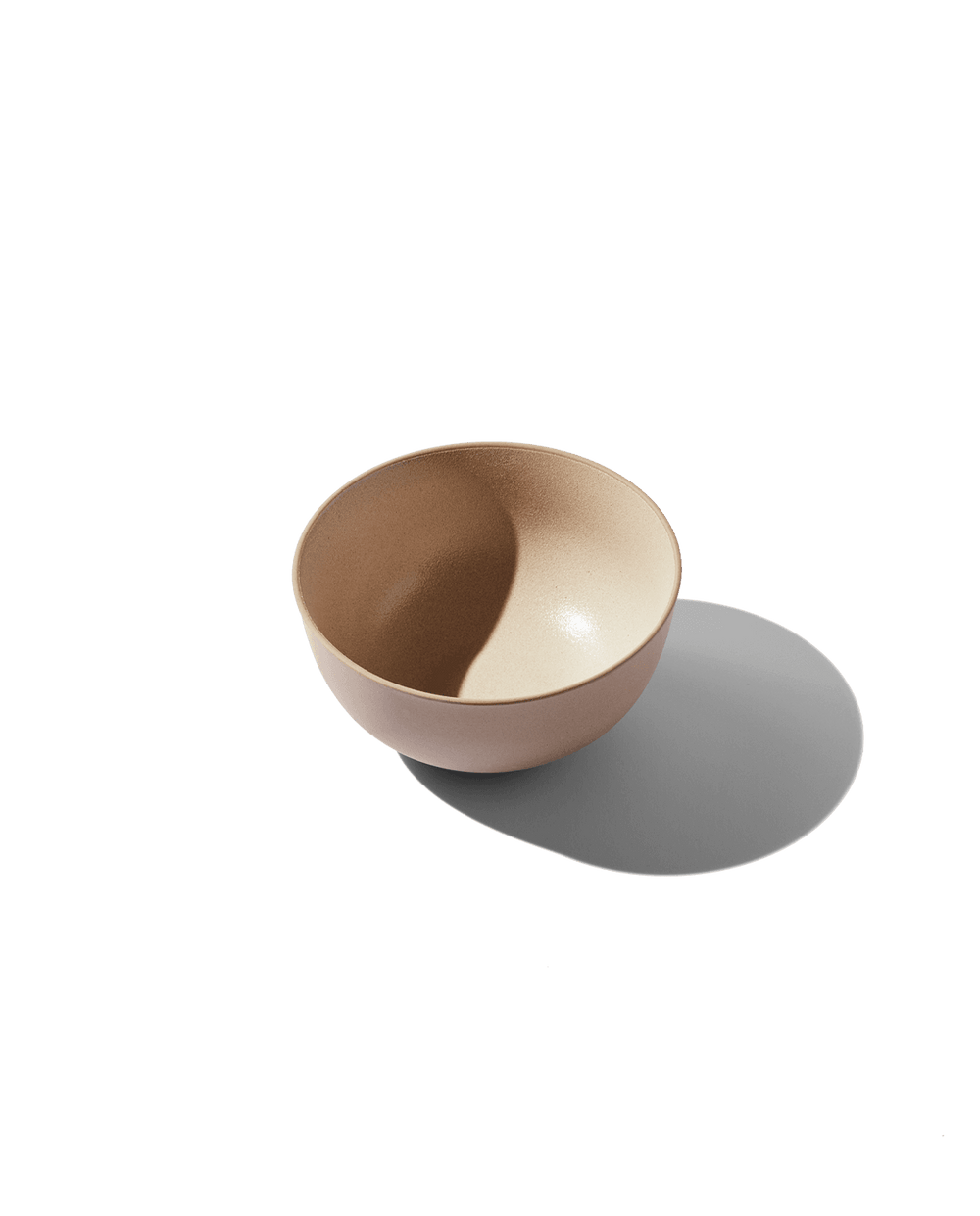 Angled top-down view of Round Bowl showcasing two-tone dune glaze and rounded shape on white background
