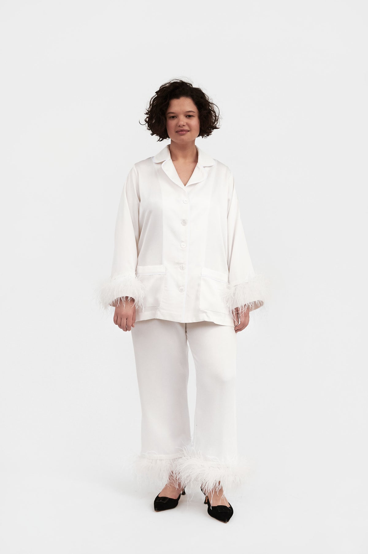Front view of Party Pajama Set with Double Feathers in White showcasing feather cuffs and oversized fit on a model