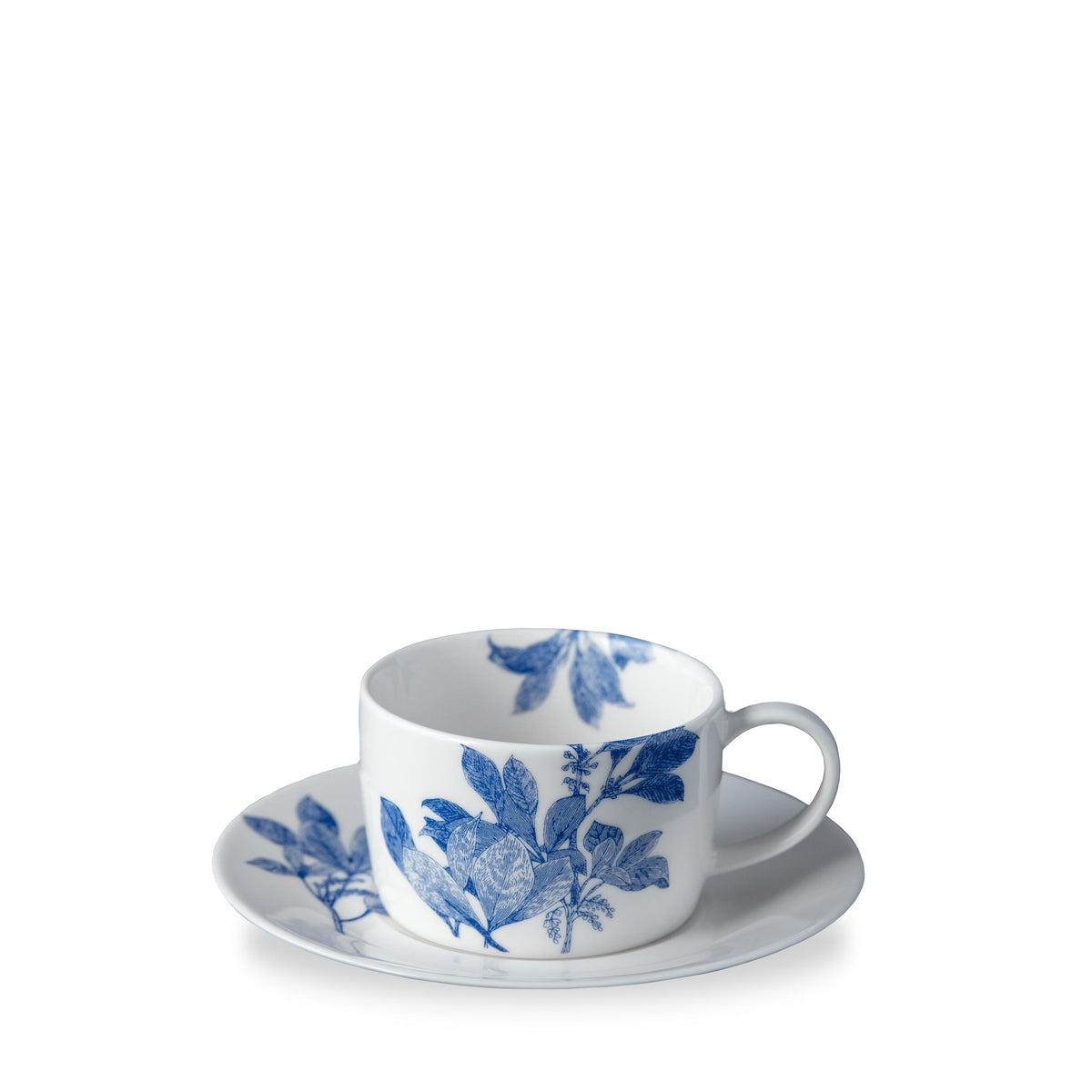 Three quarter view of Blue Arbor Cup and Saucer showcasing blue leafy branches on white porcelain with a white background