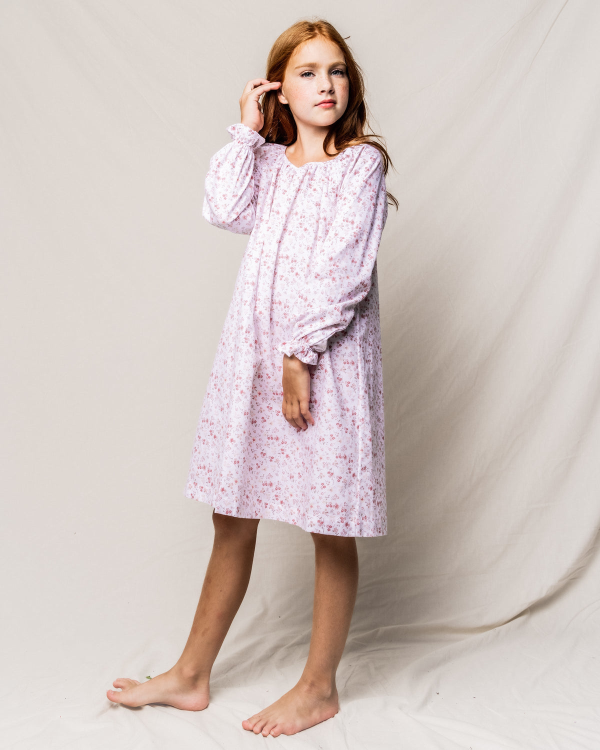 Front view of Children’s Dorset Floral Delphine Nightgown showcasing pink floral print, chest tie, and bell sleeves on a model