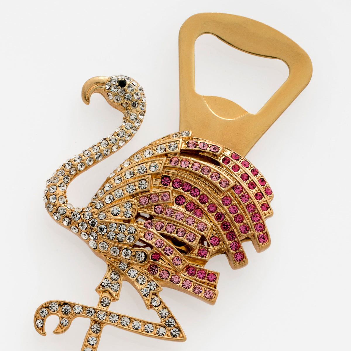 Angled top-down view of flamingo bottle opener showcasing gold-tone finish and pink and clear rhinestones on white background