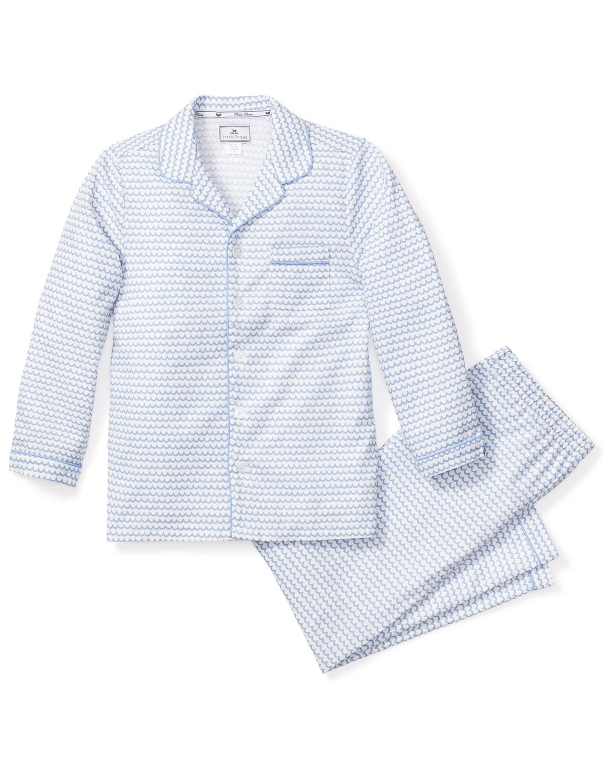 Flat lay of La Mer pajama set showcasing light-blue wave print, contrast piped collar and chest pocket on white background