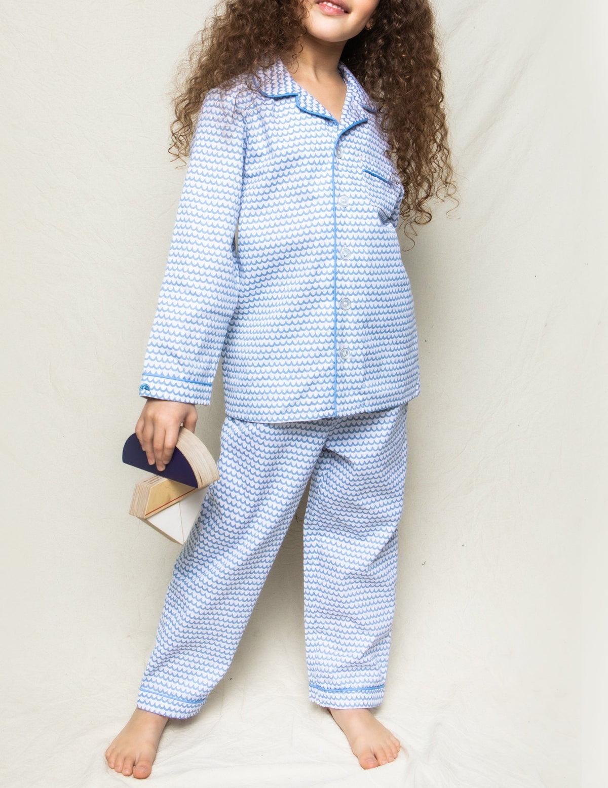 Front view of La Mer pajama set showcasing blue wave print, contrast piping, button-front top and matching pants on neutral background