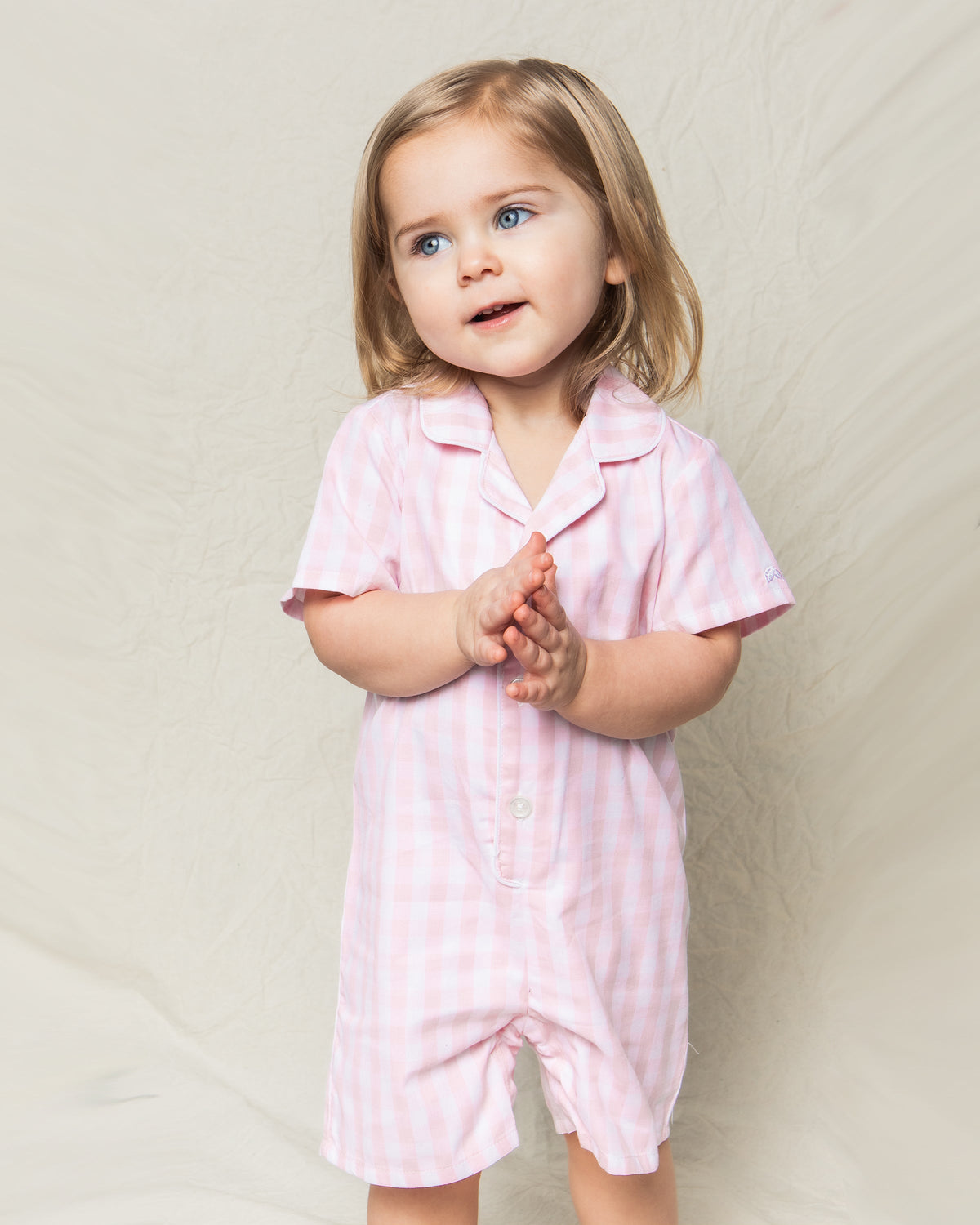 Front view of Children’s Pink Gingham Summer Romper showcasing delicate collar and button front with neutral background