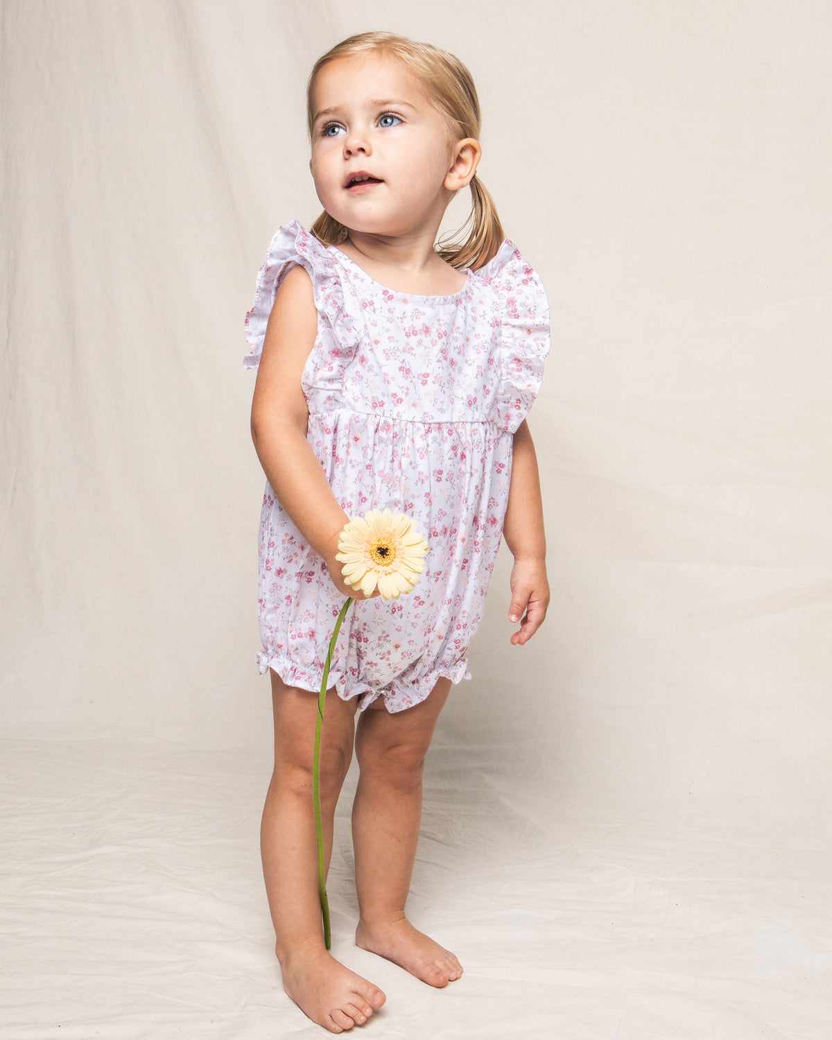 Front view of Children’s Dorset Floral Ruffled Romper showcasing its floral print and ruffled sleeves on a child against a light background