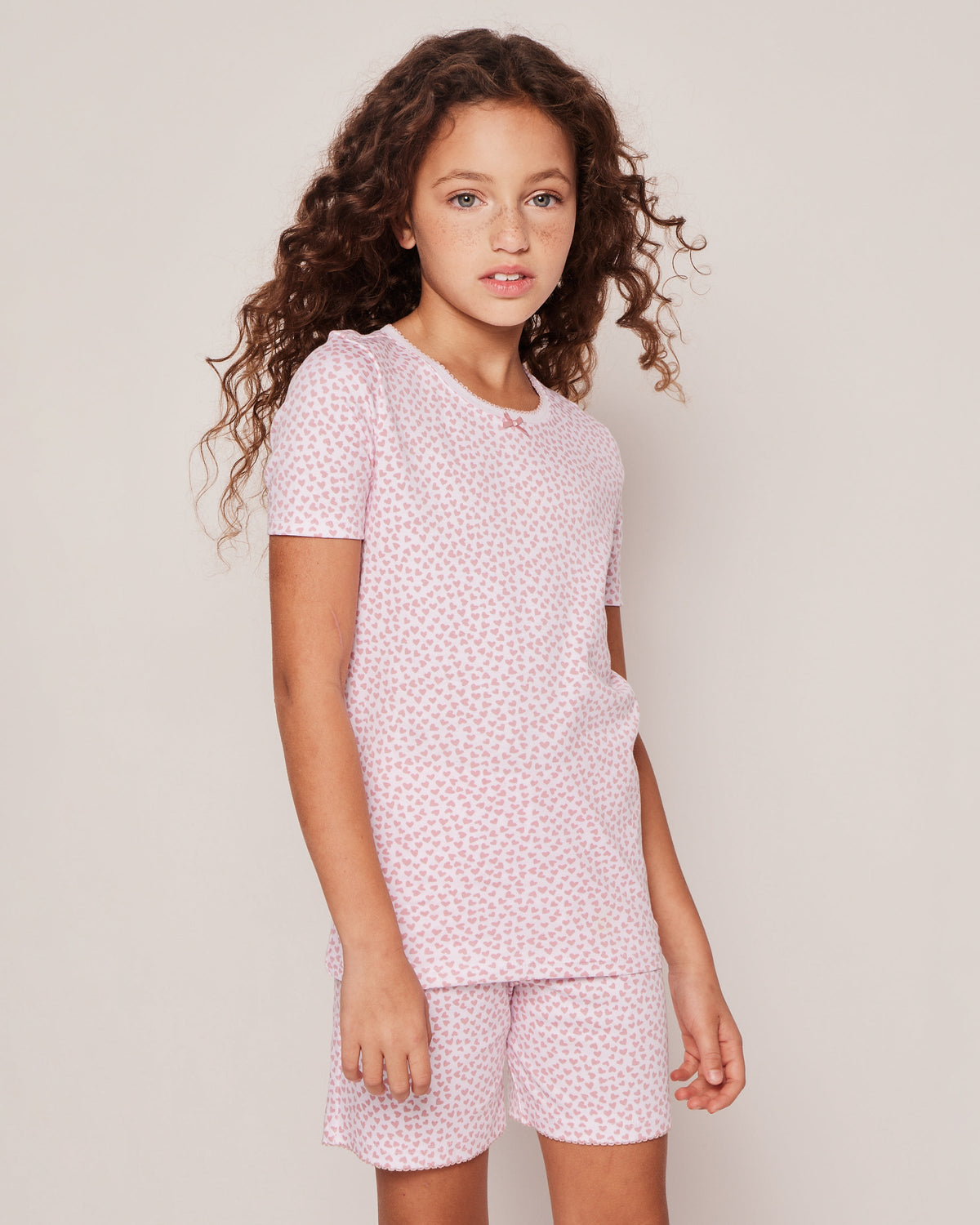 Front of Sweethearts Pima Cotton snug-fit short set on model showing pink heart print and scalloped trim
