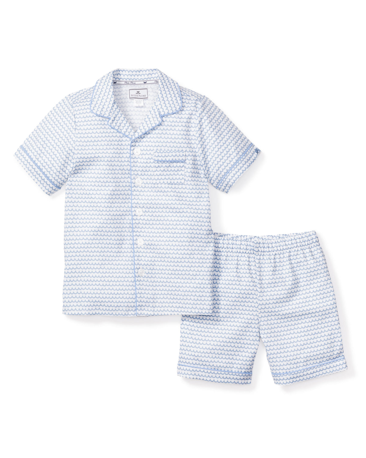 Flat lay of La Mer short pajama set in blue scallop print, button-front top and elastic-waist shorts on white background