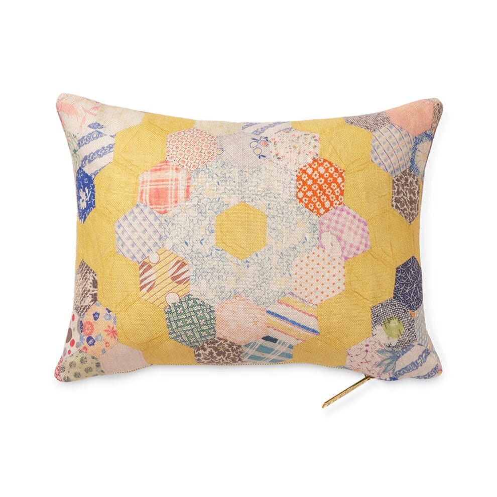 Front view of Butter Diamond Quilt Pillow with yellow hexagon patchwork and exposed gold zipper on white background