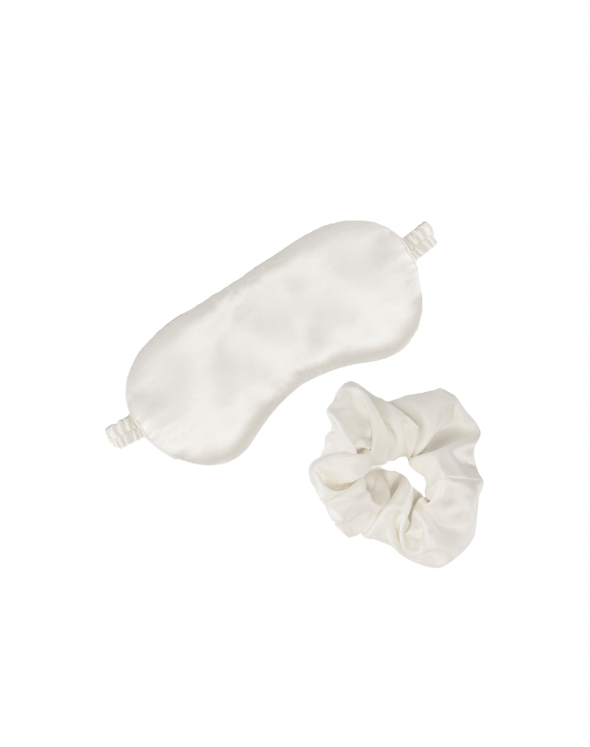Top view of the Love Me Tender Silk Self Love Set showcasing a white silk sleeping mask and matching scrunchie on a white background