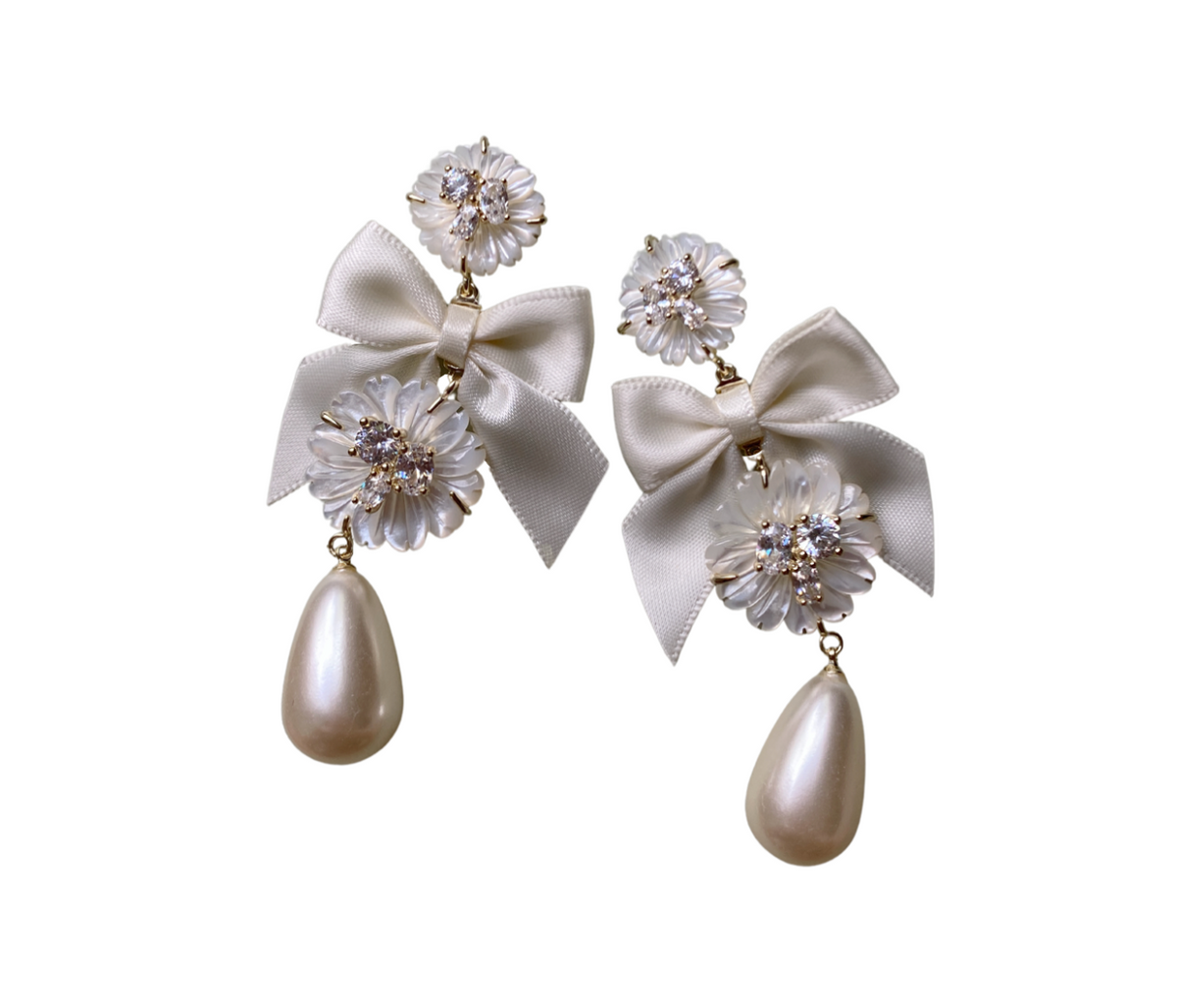 Front view of Embellished Mother of Pearl and Ivory Bow Earrings showcasing ivory bows and floral mother-of-pearl details