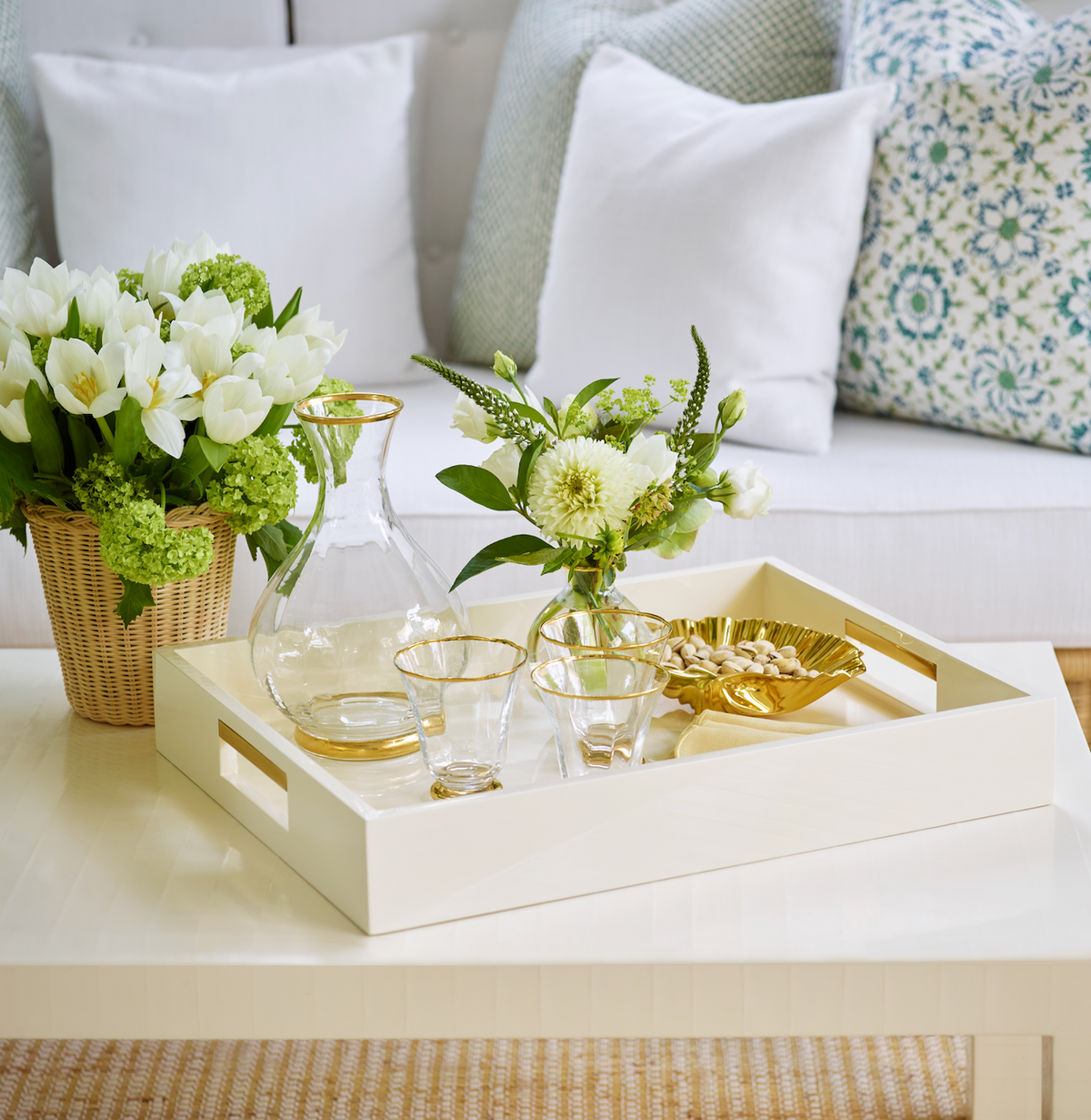 Front view of Sophia Tumbler set of four showcasing fluted crystal glasses with gold rims on a floral tray setting