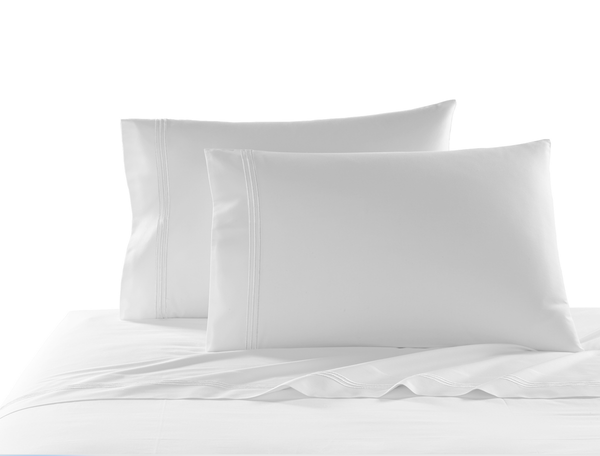 Front view of Strada king flat sheet showcasing three-stripe embroidered hem with two matching pillows on white background