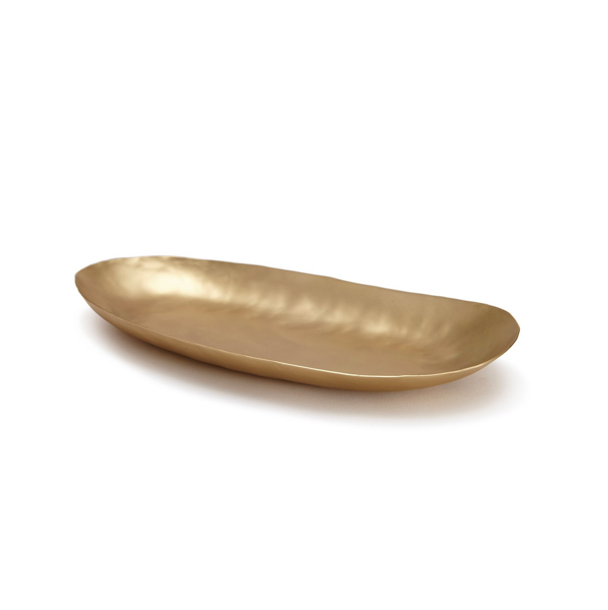 Angled view of Nile Bath Tray showcasing brass construction and gently curved shallow oval shape on white background