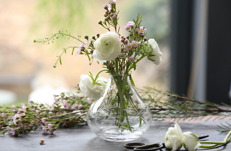 Front view of Small Crystal Vase with Fern Design showcasing its engraved fern design with flowers on a table