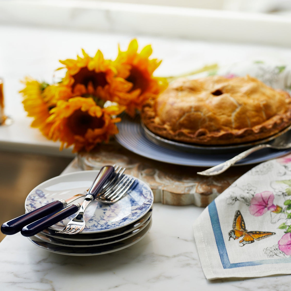 A Summer Blues Canapé Plate from Caskata with a summer pie on it.