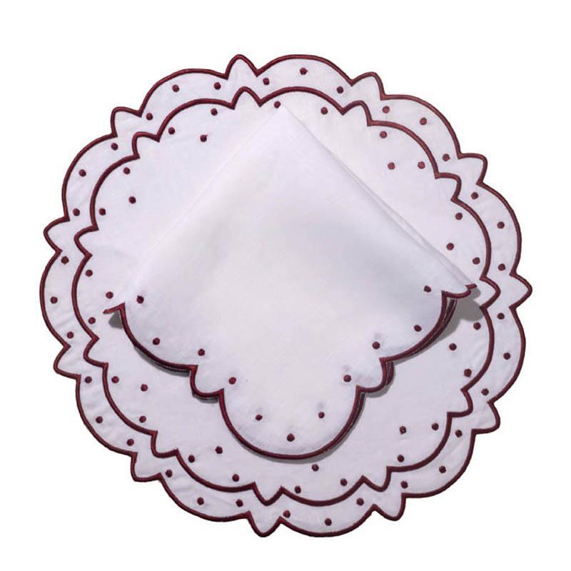 Overhead view of Suzette linen placemat and napkin set with burgundy embroidered scalloped edges and dots on white