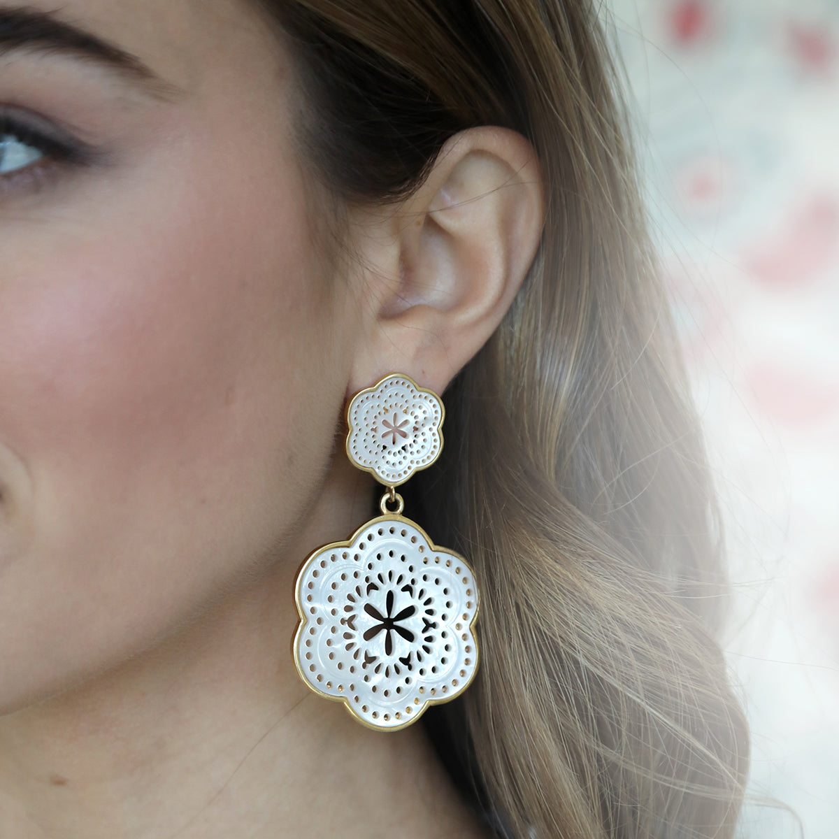 Close-up side view of Tamarin Drop Large earring showcasing floral mother-of-pearl design on a model’s ear