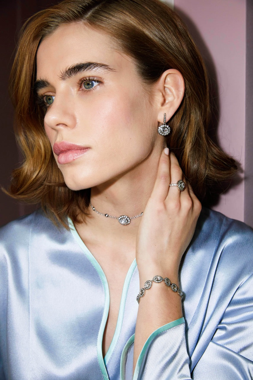 Model wearing Lexie choker with 1.4 carat white topaz and diamond by the yard chain, close-up portrait with satin robe