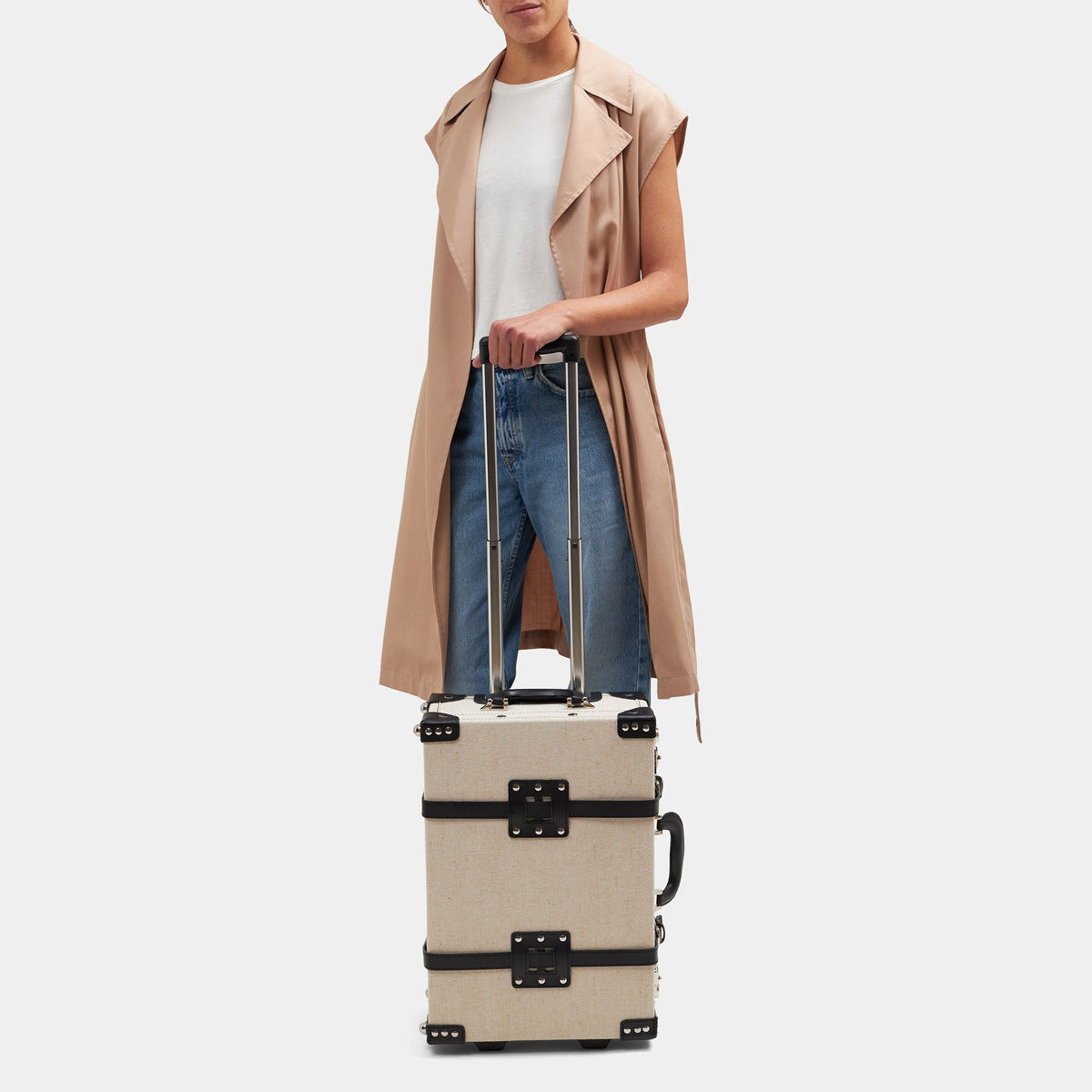 Front view of The Editor in Black Carryon with ivory body, black straps, and extended handle against gray background