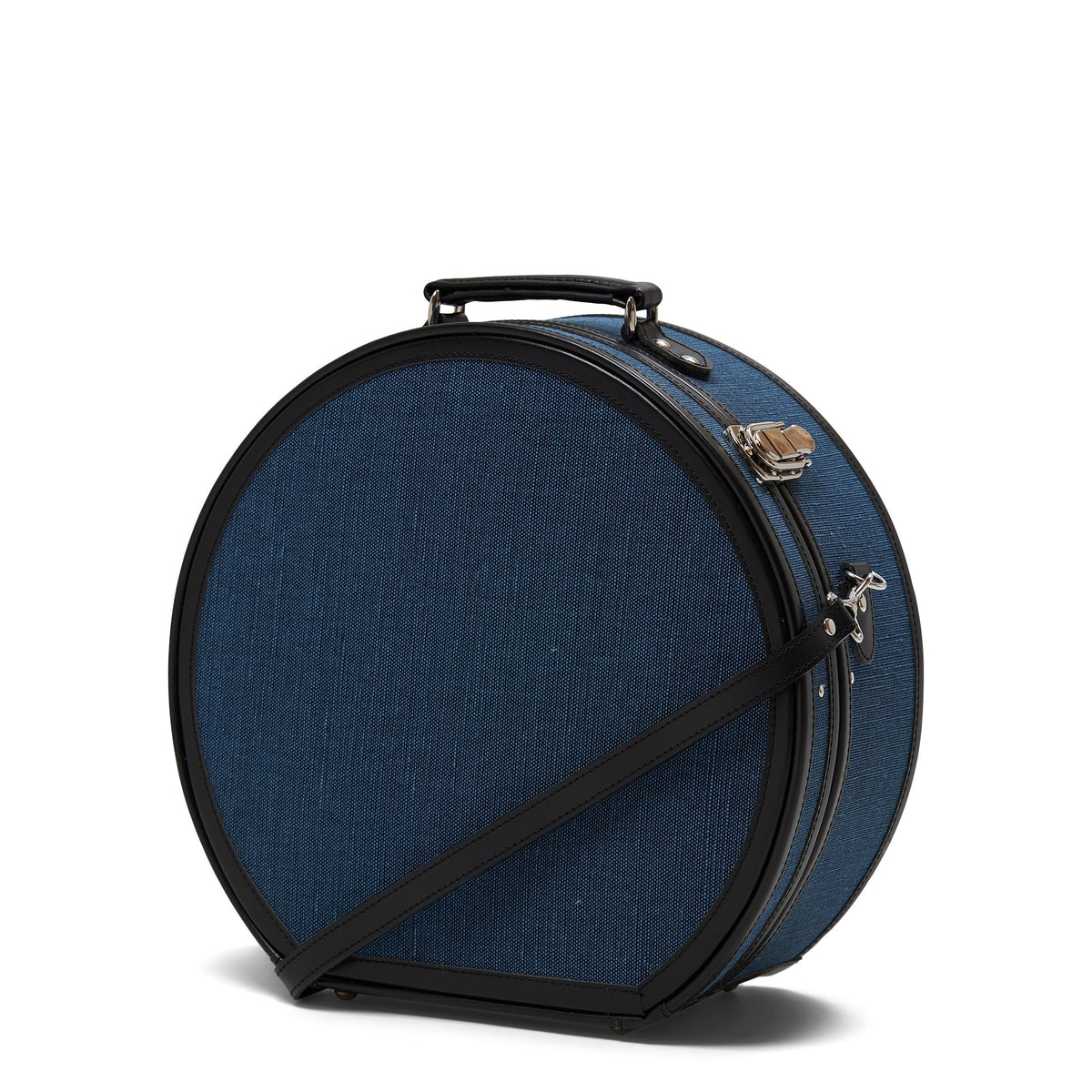 Front three-quarter view of The Editor Large Hatbox showcasing navy body, silver latches, and black straps with white background
