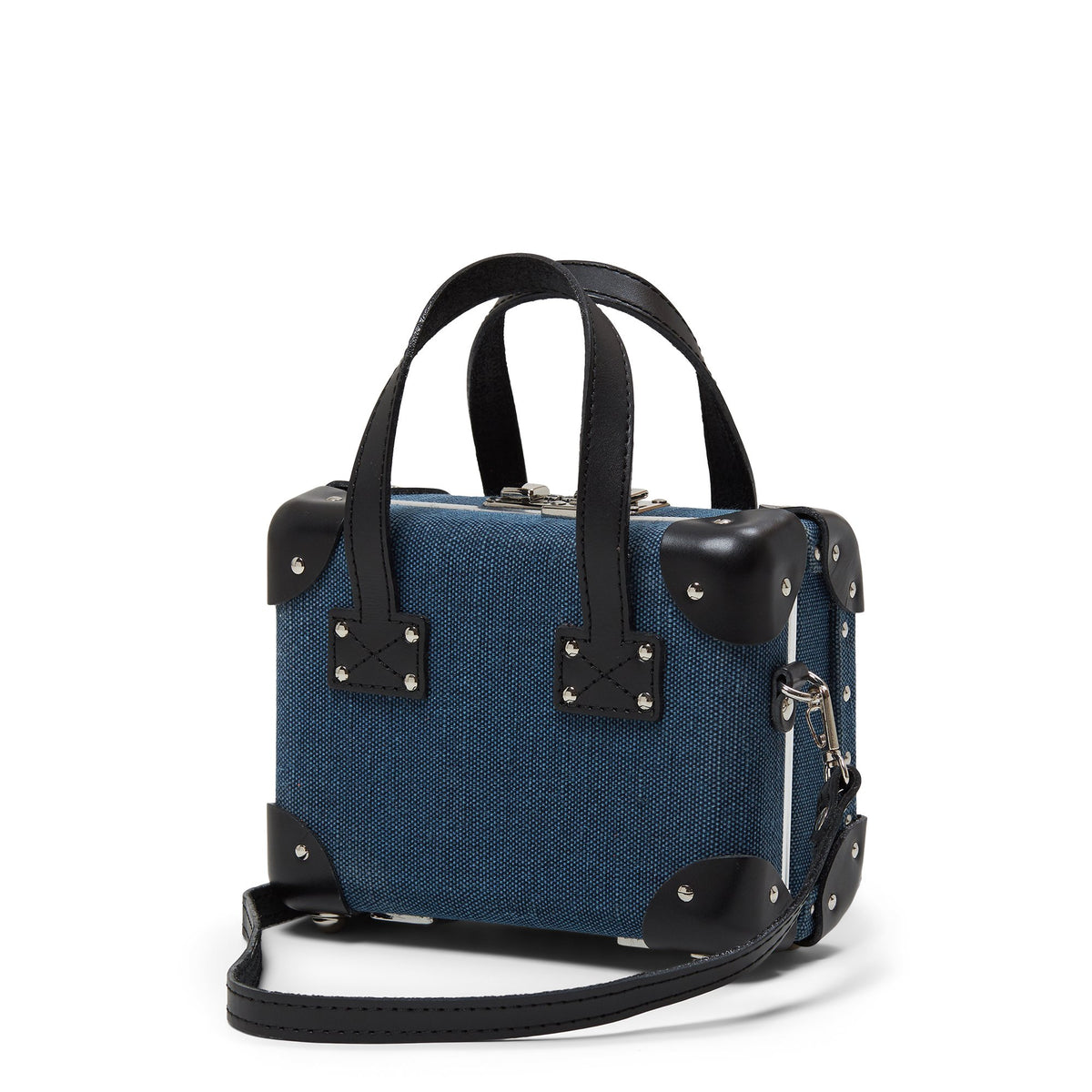 Front three-quarter view of The Editor Mini showcasing navy linen, black leather straps, and detachable shoulder strap against a white background