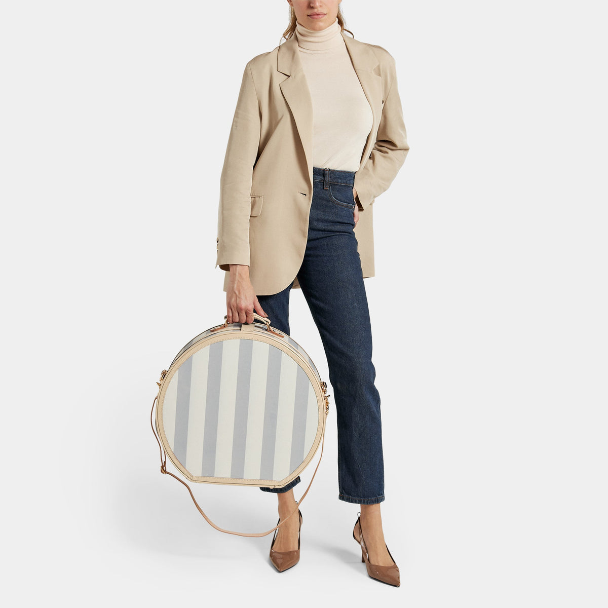 Front view of The Illustrator Deluxe Blue Hatbox showcasing striped blue body and tan leather trim with model holding it