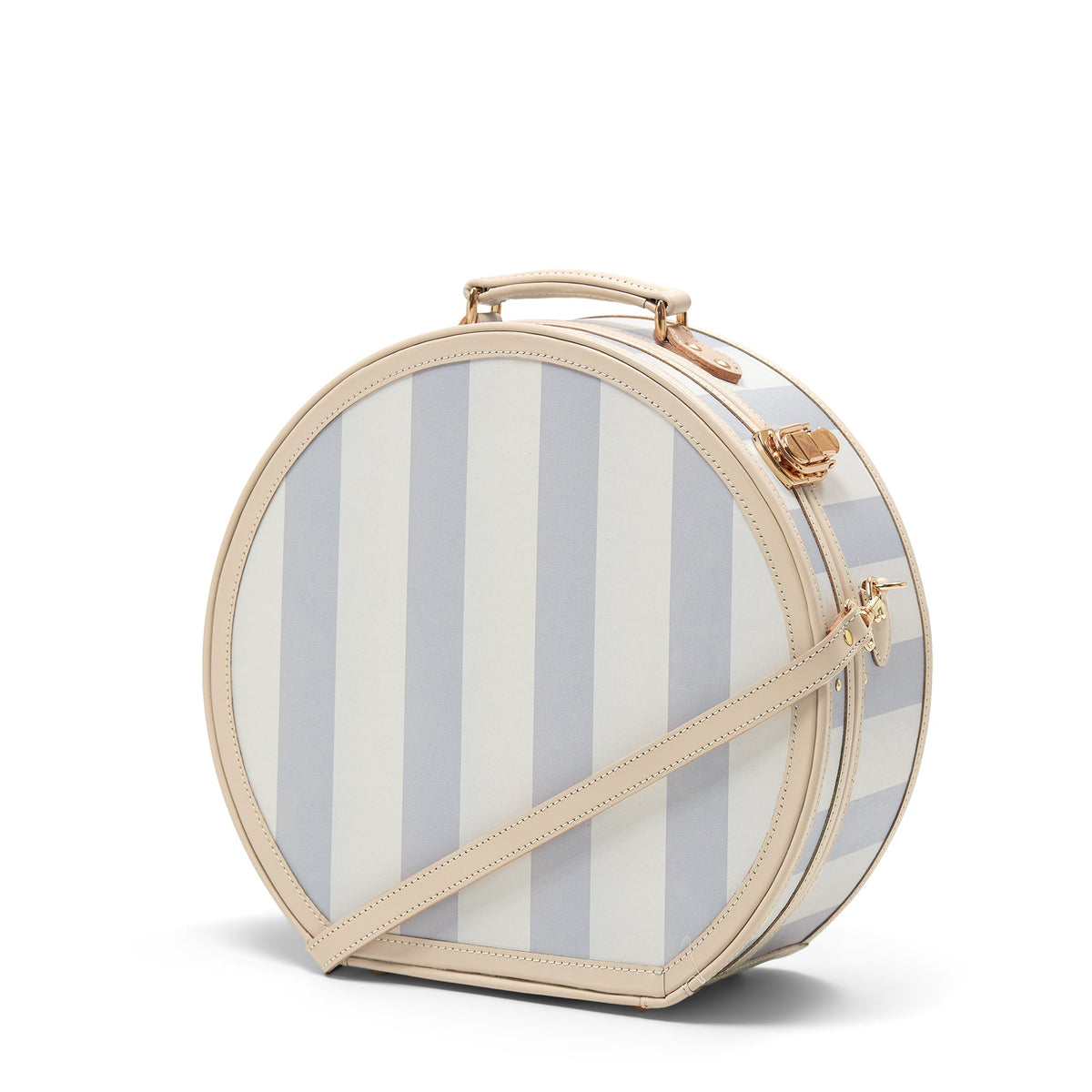 Three-quarter front view of The Illustrator large blue striped hatbox showcasing tan leather trim, detachable shoulder strap and gold hardware with white background