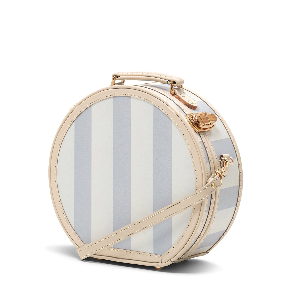 Angled front view of The Illustrator Small Blue Hatbox showcasing blue stripes, tan leather trim, and gold hardware on white