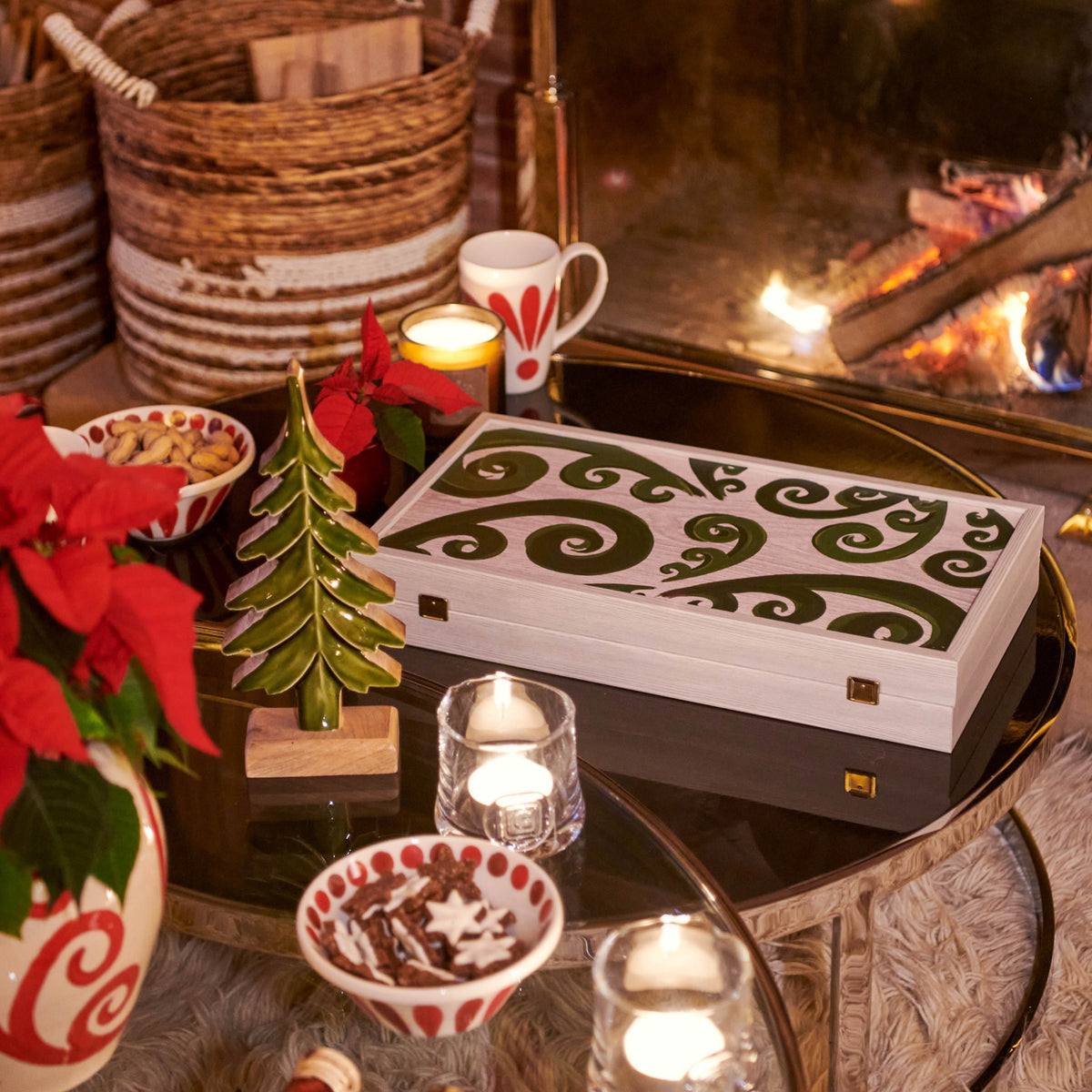 Angled view of Peacock Backgammon showcasing green swirl patterns on a white board with festive table setting