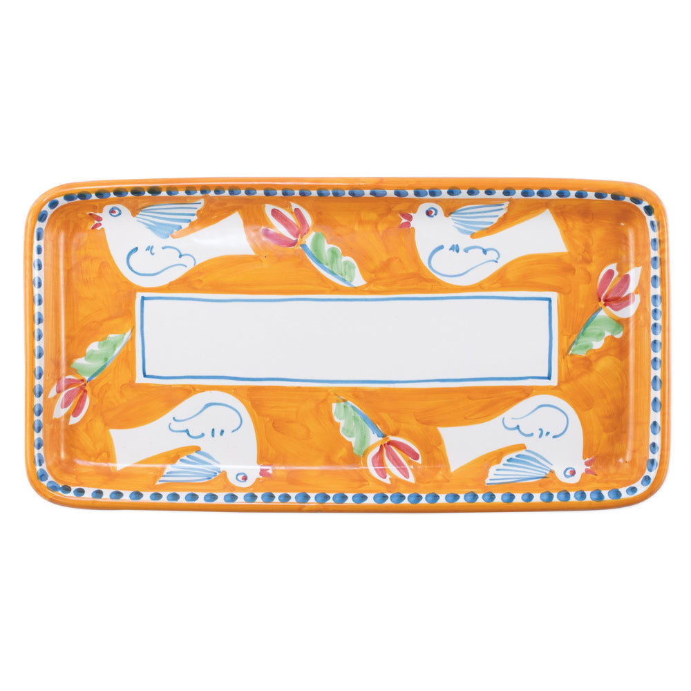 Top view of Campagna rectangular platter: orange ceramic, blue dotted rim, white center, birds and tulips