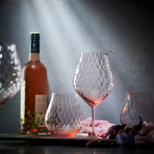 Phoebe rose pink mouth blown diamond optic crystal glasses from Caskata, both universal stemware and stemless wine glasses pictured.