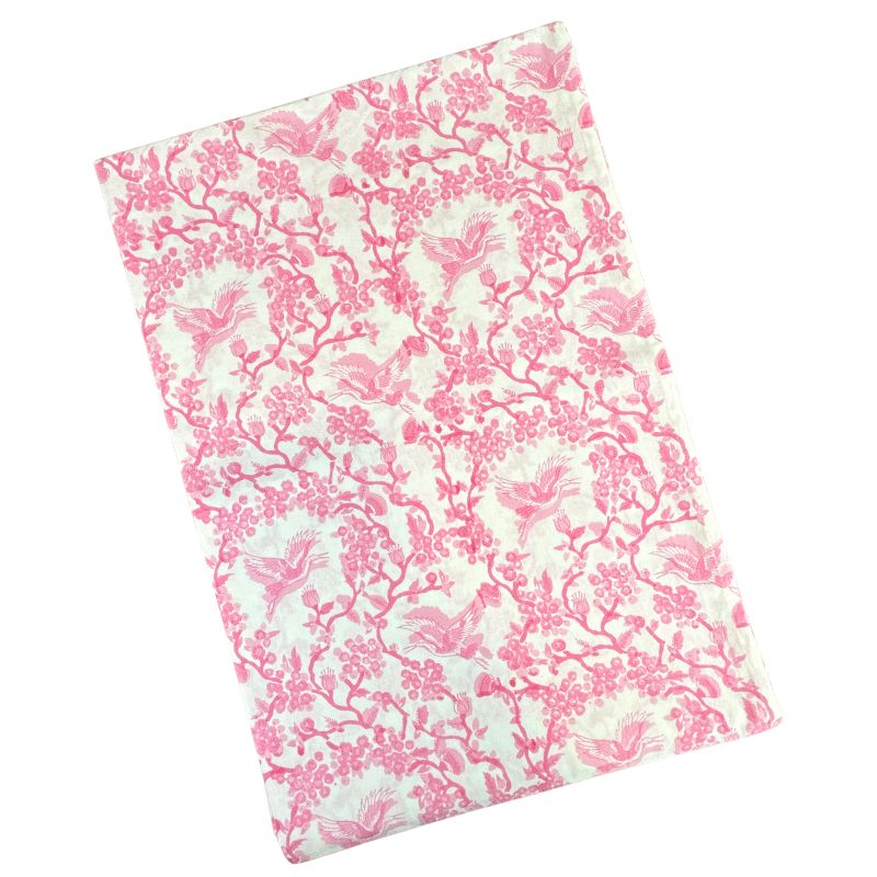 Angled view of Toile de Jouy Birds Pink Tablecloth showcasing pink birds and floral branches on a cream background